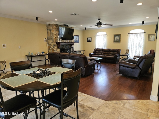 dining room with crown molding, hardwood / wood-style flooring, and ceiling fan