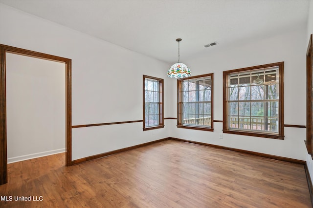 unfurnished room with hardwood / wood-style floors