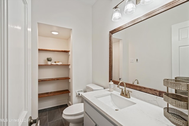 bathroom with tile patterned floors, vanity, and toilet