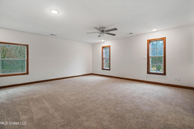 spare room with carpet and ceiling fan