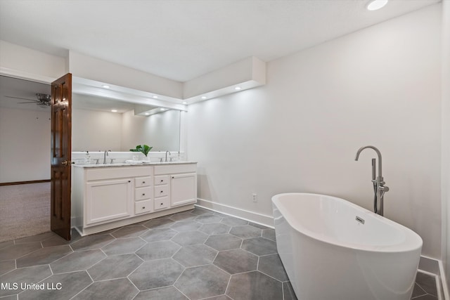 bathroom with a bathing tub, ceiling fan, and vanity