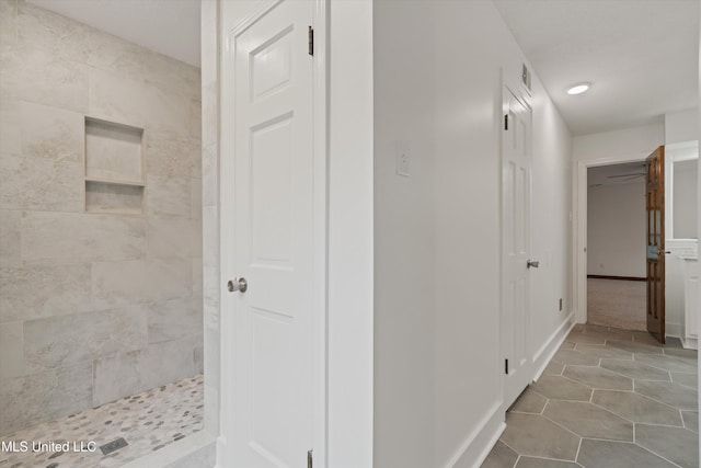 hall featuring light tile patterned floors