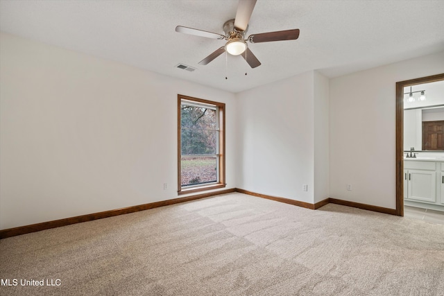 interior space featuring light carpet, ceiling fan, and sink