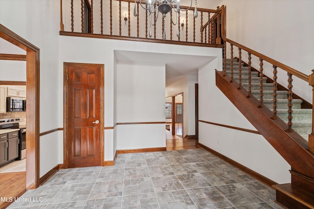 entryway with a high ceiling and an inviting chandelier