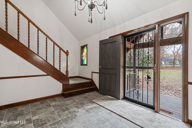 foyer featuring an inviting chandelier and lofted ceiling