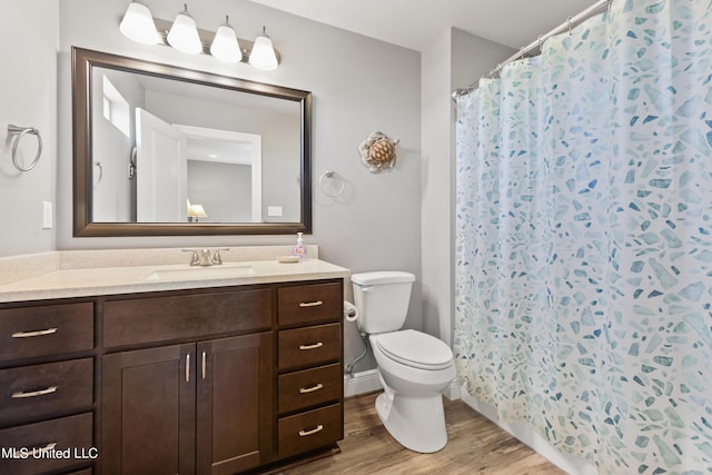 full bathroom featuring vanity, toilet, and wood finished floors