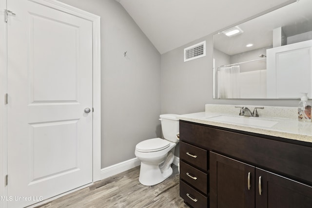 full bathroom with visible vents, toilet, wood finished floors, curtained shower, and vanity