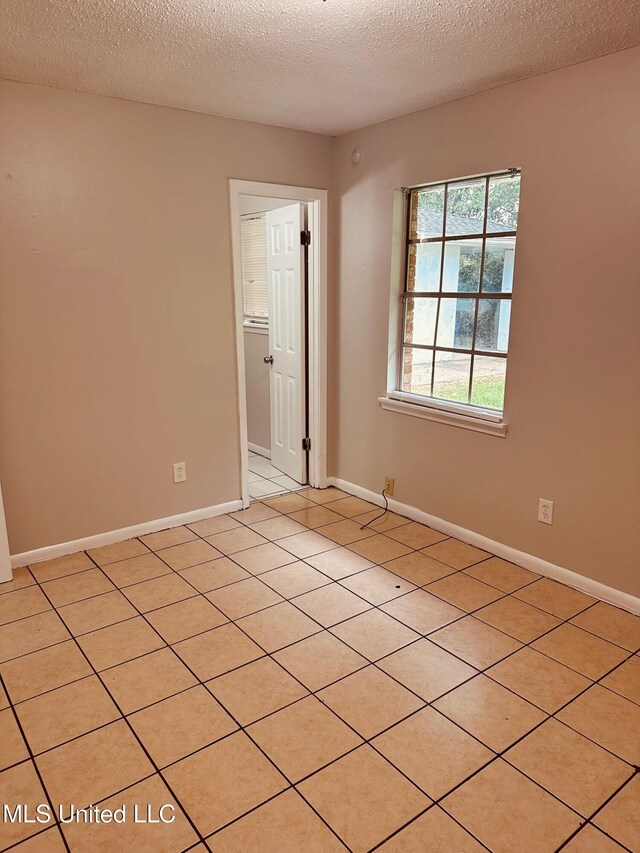 143 James Dr, Gulfport, MS 39503 - unfurnished room with a textured ceiling, light tile patterned floors, and baseboards