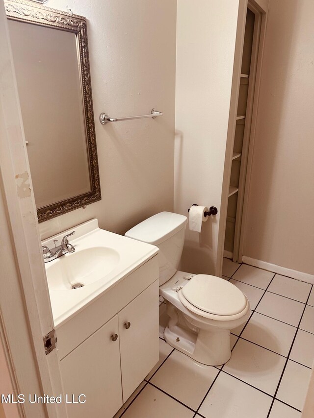 143 James Dr, Gulfport, MS 39503 - half bath with vanity, tile patterned floors, and toilet