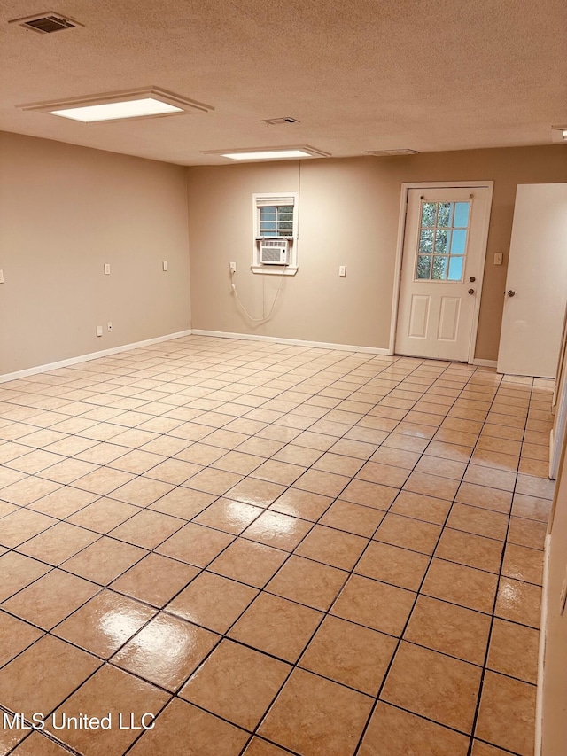 143 James Dr, Gulfport, MS 39503 - spare room featuring a textured ceiling, cooling unit, baseboards, and light tile patterned floors