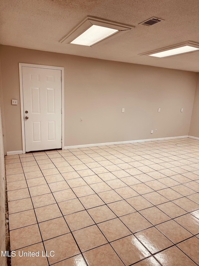 143 James Dr, Gulfport, MS 39503 - spare room with a textured ceiling, light tile patterned flooring, and baseboards