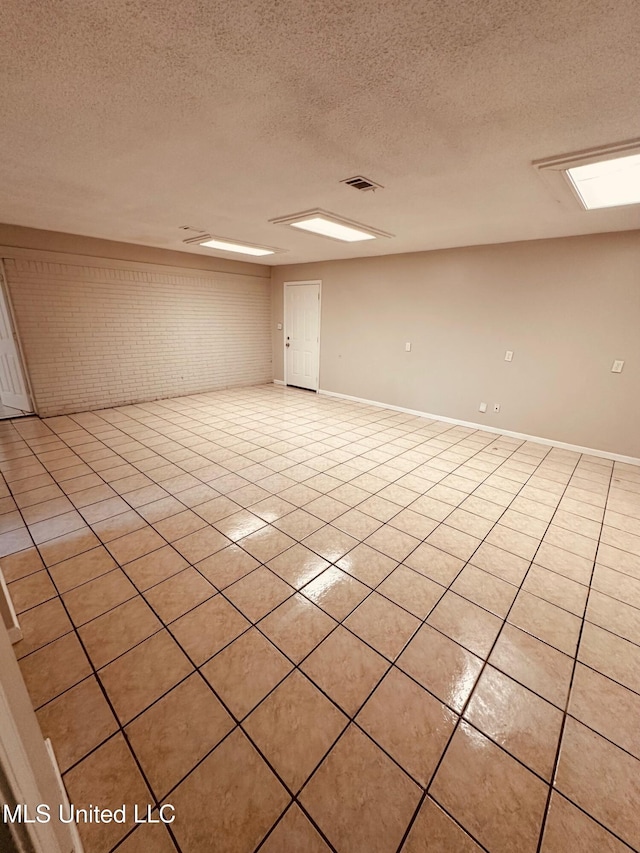 143 James Dr, Gulfport, MS 39503 - unfurnished room featuring light tile patterned floors, a textured ceiling, and baseboards
