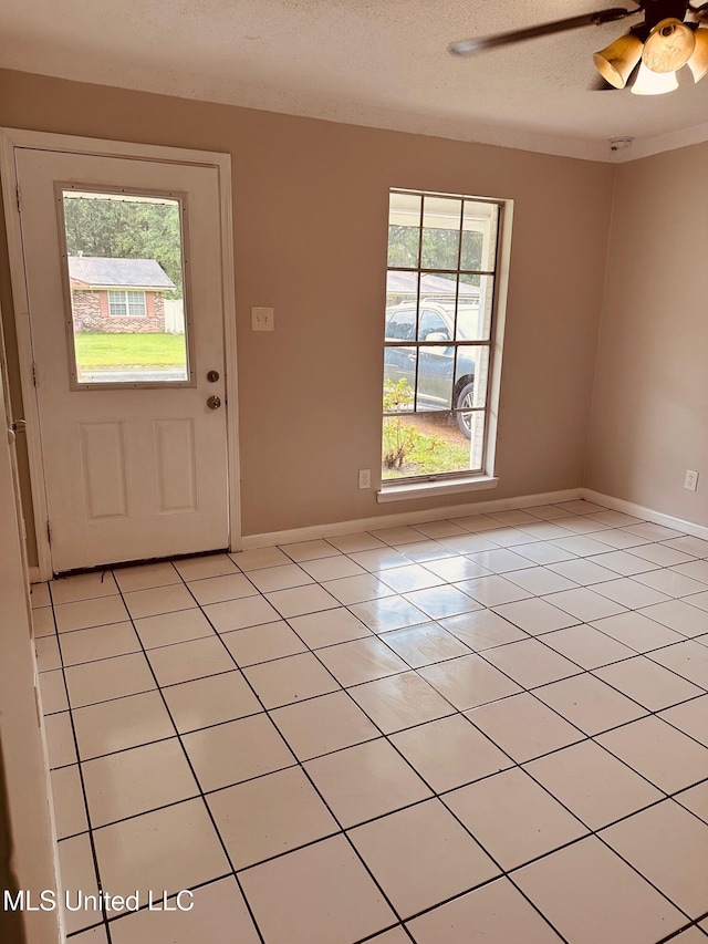 143 James Dr, Gulfport, MS 39503 - foyer entrance featuring light tile patterned floors, baseboards, a textured ceiling, and ceiling fan