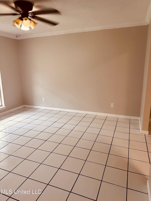 143 James Dr, Gulfport, MS 39503 - empty room featuring a ceiling fan, ornamental molding, light tile patterned floors, and baseboards