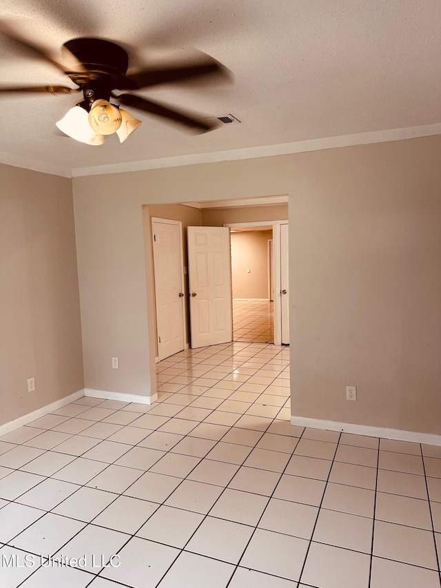 143 James Dr, Gulfport, MS 39503 - unfurnished room featuring crown molding, ceiling fan, baseboards, a textured ceiling, and light tile patterned flooring