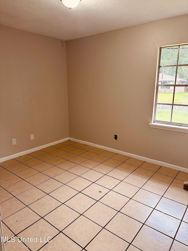 143 James Dr, Gulfport, MS 39503 - spare room with a textured ceiling, light tile patterned floors, and baseboards