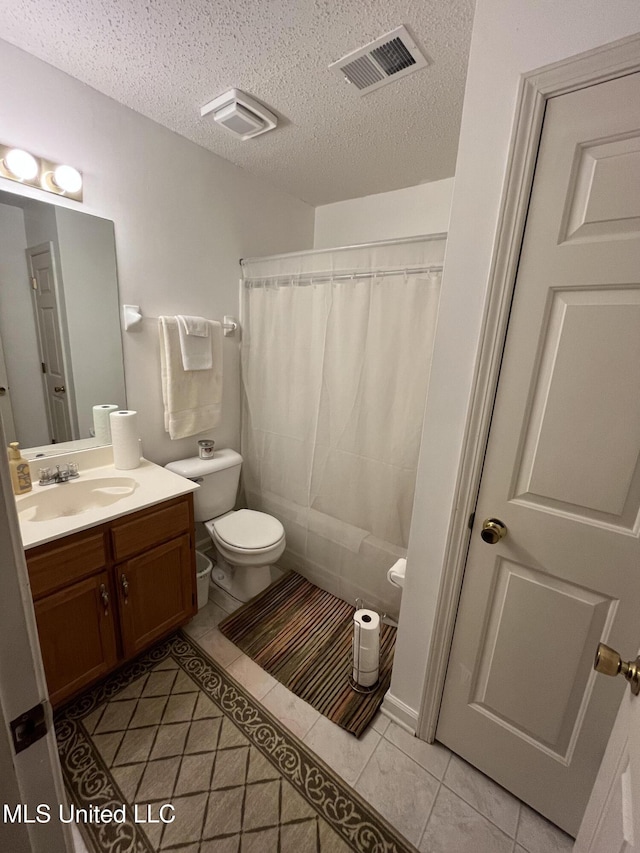 7605 Davis Pkwy, Southaven, MS 38671 - full bathroom with tile patterned flooring, vanity, a textured ceiling, and a shower with shower curtain