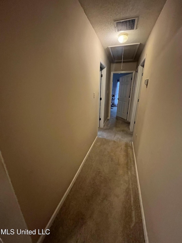 7605 Davis Pkwy, Southaven, MS 38671 - hall featuring attic access, light colored carpet, and a textured ceiling