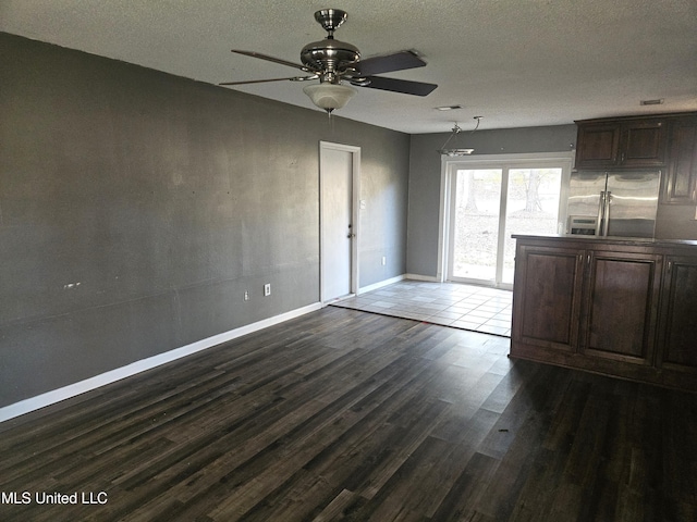 interior space with dark hardwood / wood-style floors, ceiling fan, and a textured ceiling