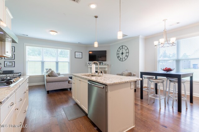 kitchen with appliances with stainless steel finishes, dark hardwood / wood-style floors, white cabinetry, and an island with sink