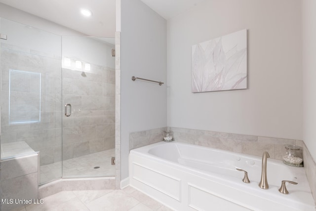 bathroom with shower with separate bathtub and tile patterned floors