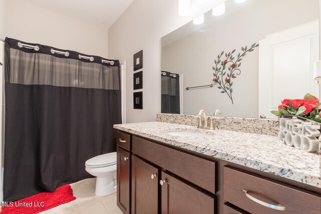 bathroom with vanity, walk in shower, toilet, and tile patterned floors