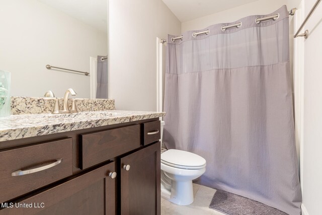 bathroom with vanity, toilet, tile patterned floors, and a shower with shower curtain