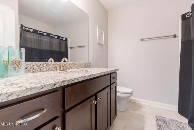 bathroom with vanity, toilet, and tile patterned floors