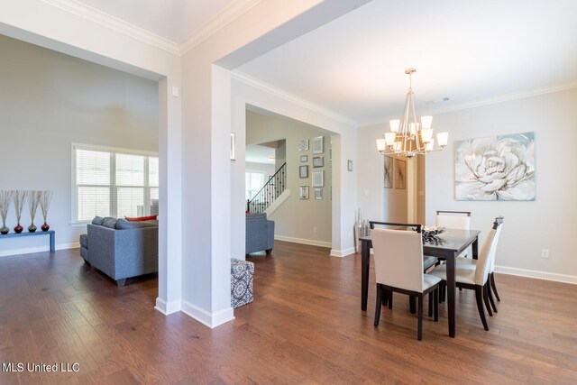 dining area with crown molding, an inviting chandelier, and dark hardwood / wood-style flooring