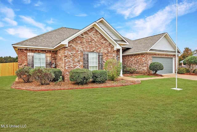 view of front of home featuring a front lawn and a garage