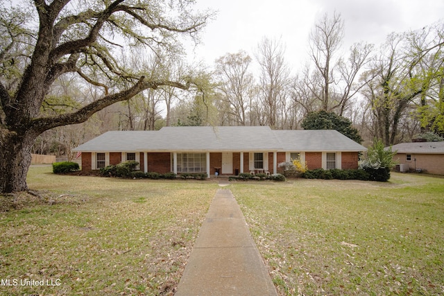 ranch-style home with a porch, brick siding, and a front yard