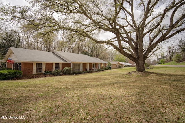 ranch-style home with brick siding and a front yard