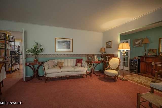 living room featuring wine cooler, ornamental molding, and carpet