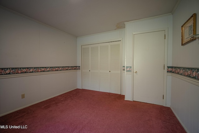 unfurnished bedroom featuring a closet, crown molding, and carpet floors