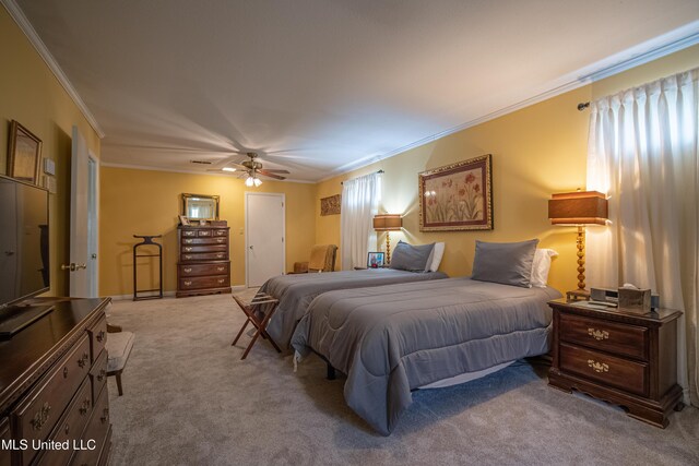 carpeted bedroom with a ceiling fan and crown molding