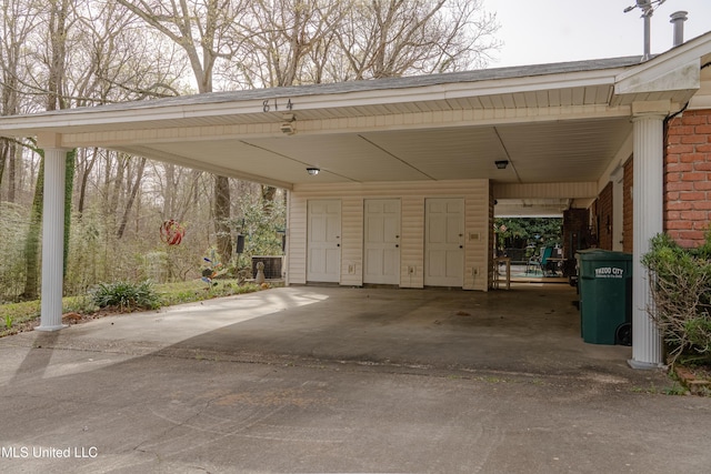 exterior space featuring an attached carport and concrete driveway