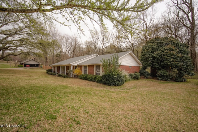 view of property exterior with brick siding and a yard