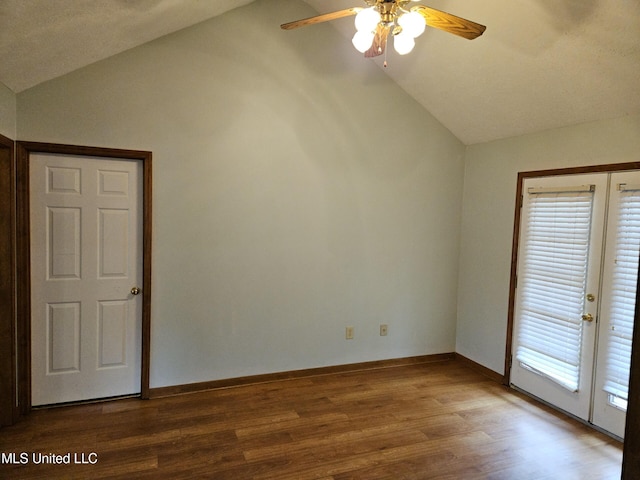 empty room with french doors, vaulted ceiling, ceiling fan, and wood-type flooring