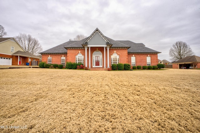 view of front of property featuring brick siding and a shingled roof