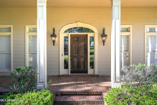 doorway to property featuring covered porch