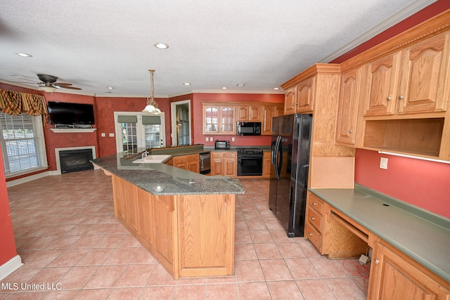 kitchen featuring black appliances, sink, decorative light fixtures, crown molding, and light tile patterned floors