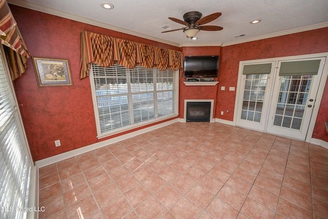 unfurnished living room with ceiling fan, a textured ceiling, and plenty of natural light