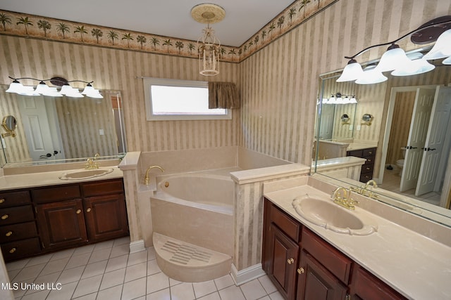 bathroom with vanity, tile patterned flooring, and a bathing tub