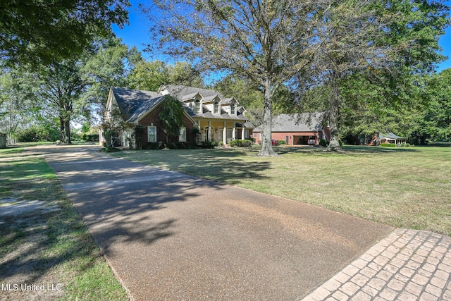 cape cod-style house with a front lawn