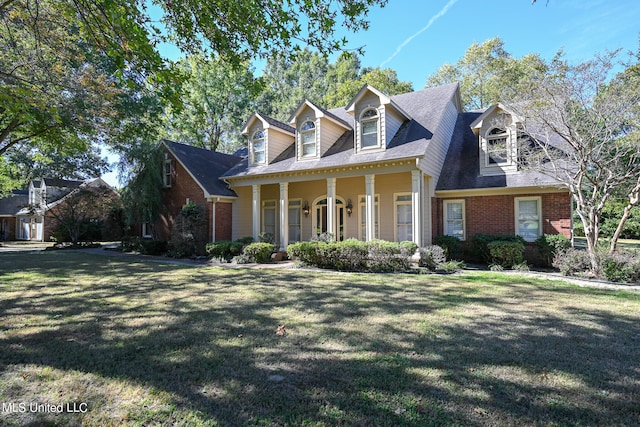 cape cod house featuring a front yard and covered porch