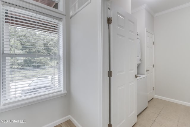 1515 E Beach Blvd Unit 132, Pass Christian, MS 39571 - hallway with stacked washing machine and dryer, crown molding, plenty of natural light, and light tile patterned floors