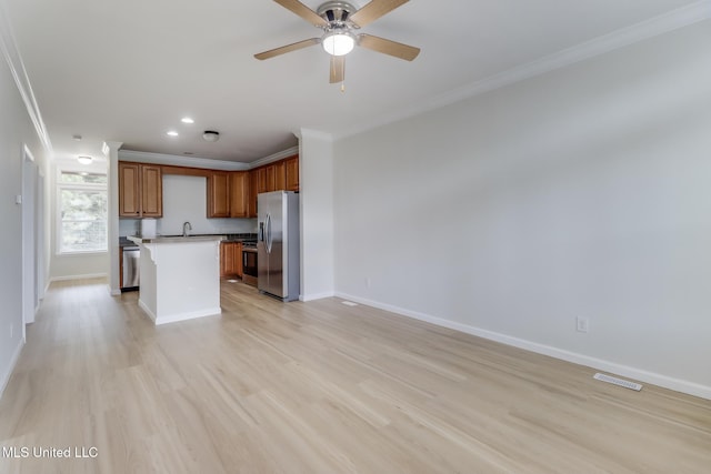1515 E Beach Blvd Unit 132, Pass Christian, MS 39571 - kitchen featuring stainless steel appliances, ornamental molding, open floor plan, a ceiling fan, and light wood-style floors