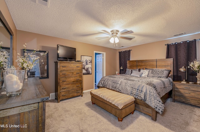 bedroom with light carpet, a textured ceiling, and ceiling fan