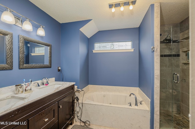 bathroom featuring vanity, a textured ceiling, and separate shower and tub