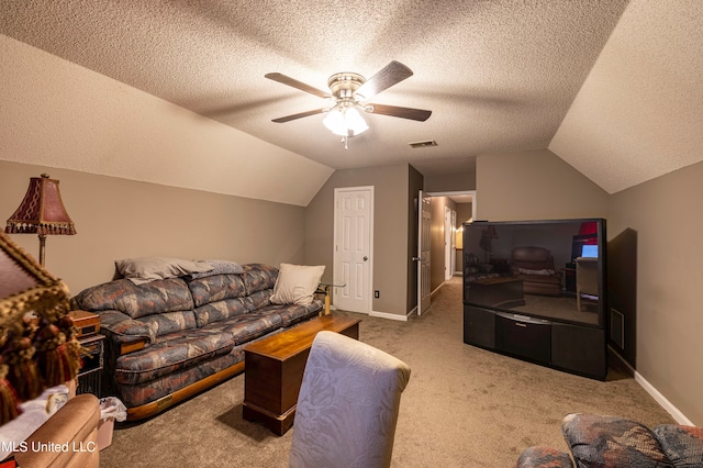 living room featuring a textured ceiling, vaulted ceiling, carpet floors, and ceiling fan